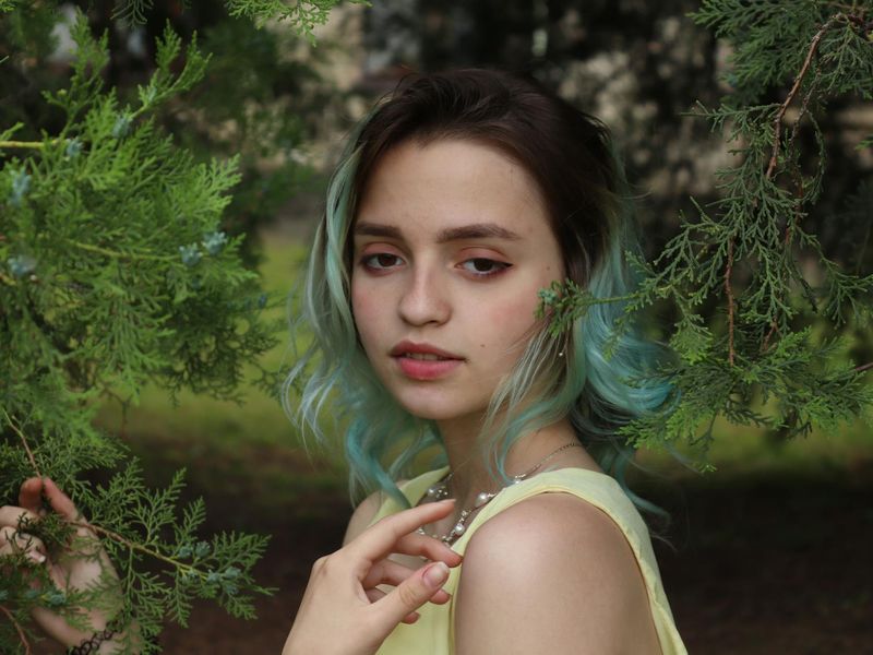Person looking at a distant green landscape for relaxation