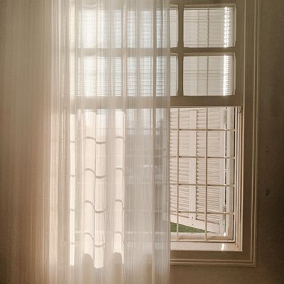 Soft sunlight falling on a window with curtains